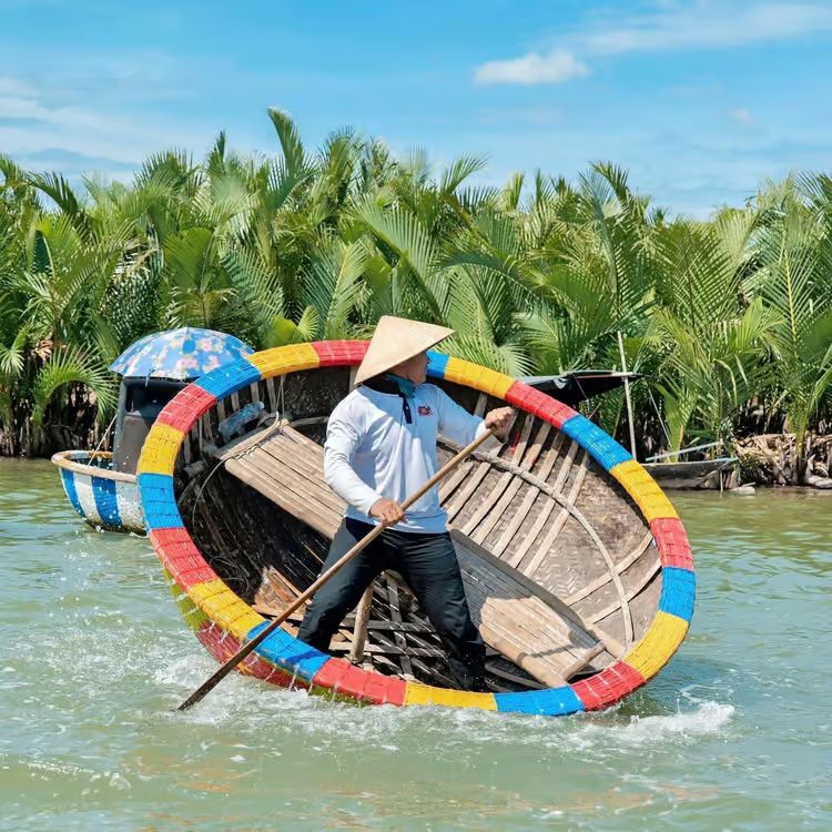 Traditional round coconut basket boat in the water-coconut forest near Hoi An