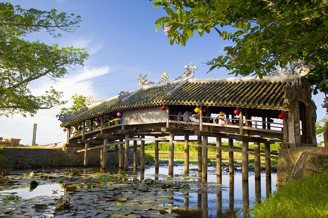 The old tiled-roof Thanh Toan bridge over a canal in the rice fields near Hue