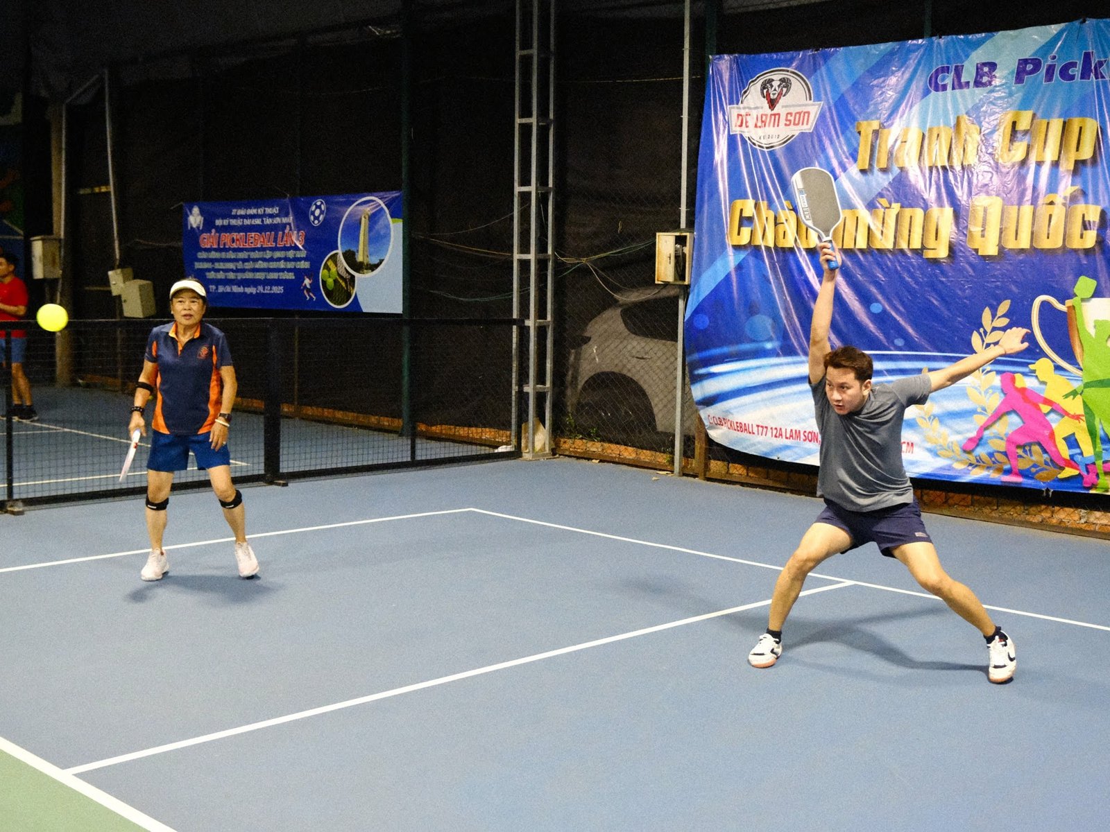 Local players in a friendly doubles game on an outdoor pickleball court in Vietnam