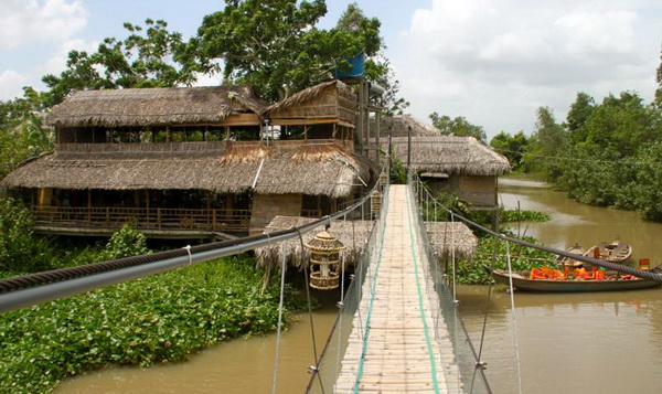 A homestay among fruit trees beside a canal in the Mekong Delta