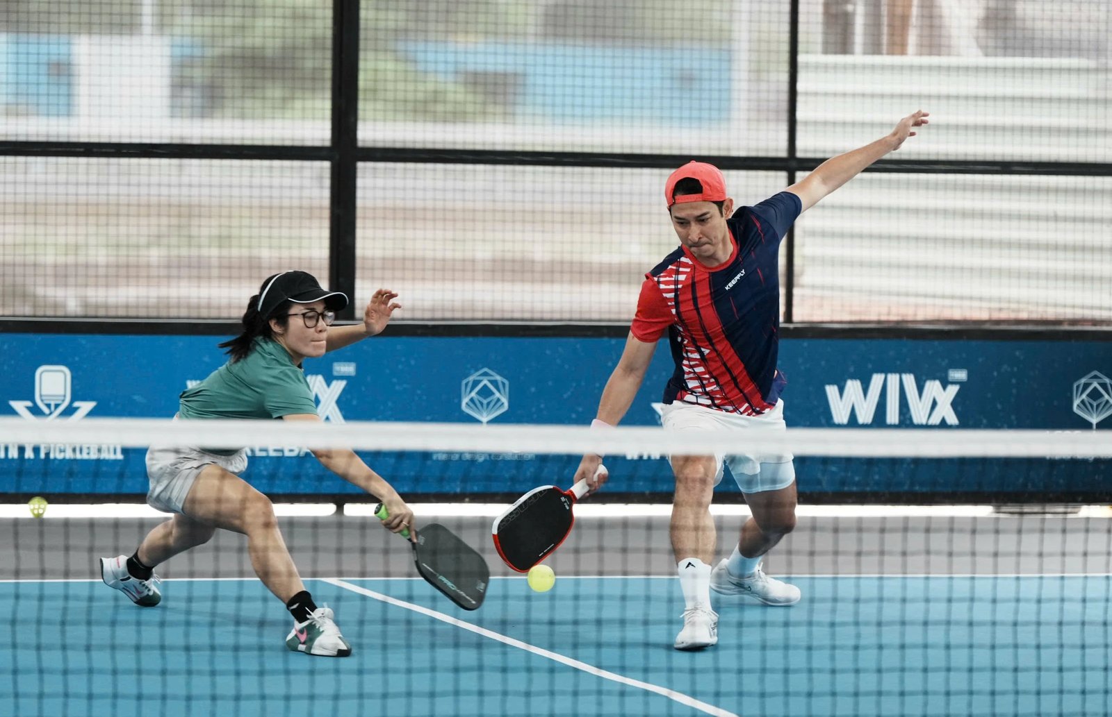 Players of different levels playing a friendly doubles game in Vietnam