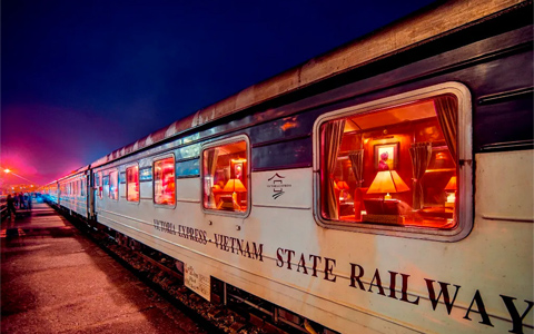 The view from a train window at night with blurred lights streaking past