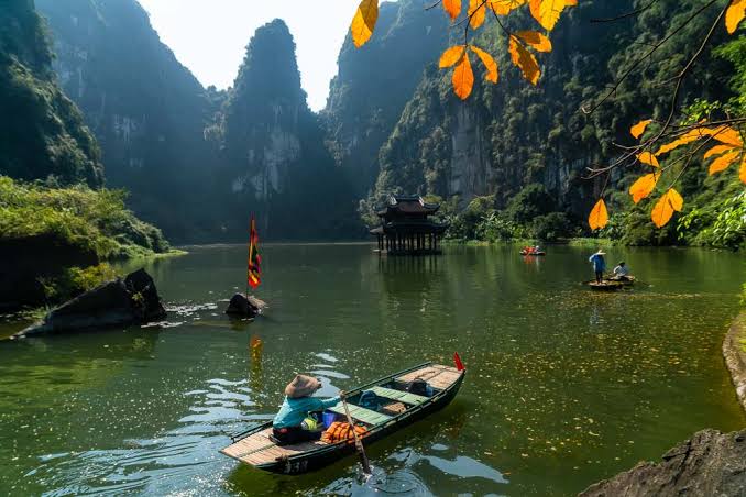 Boat on the river through Trang An's karst cliffs, Ninh Binh