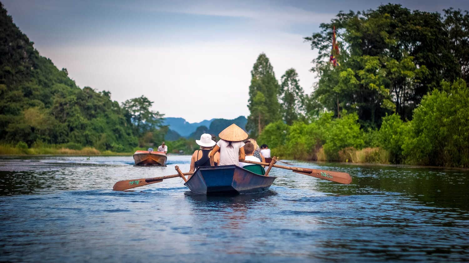 Rowing boats carrying pilgrims along the Yen stream to the Perfume Pagoda during the spring festival