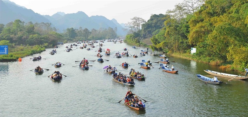 Boats carrying pilgrims along the Yen stream to the Perfume Pagoda near Hanoi during the spring festival