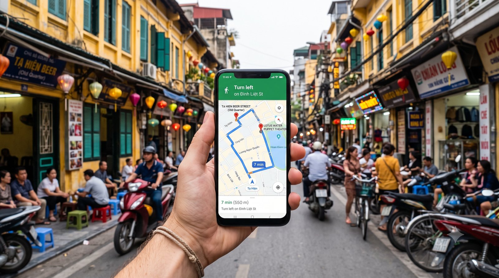 A hand holding a phone with a map app open on a city street