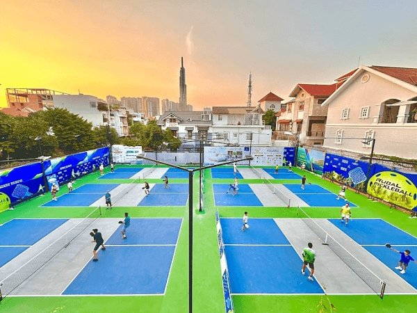 An empty outdoor pickleball court at sunrise