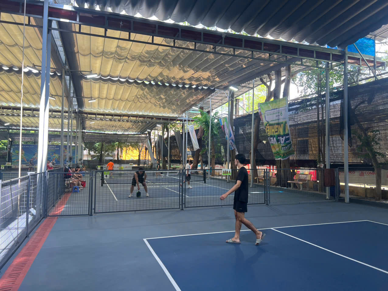 Pickleball players on a court at sunrise in Vietnam