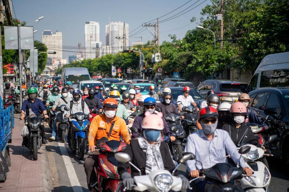 Rush hour traffic with hundreds of motorbikes in a Vietnamese city