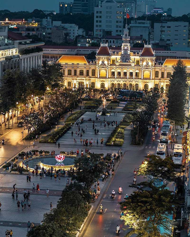 Nguyen Hue walking street and the lit-up City Hall in District 1, Ho Chi Minh City, in the evening