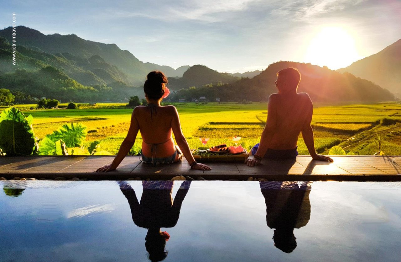 A traveller watching the sunset over rice fields in Vietnam