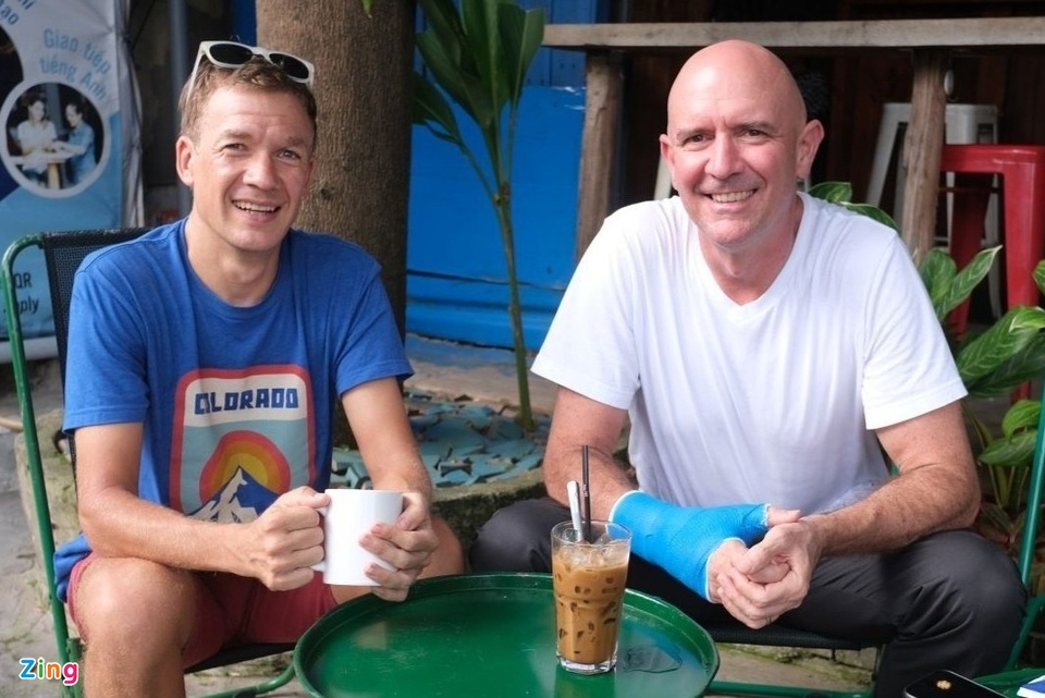 Two travellers sharing iced Vietnamese coffee at a street cafe during a two-week trip in Vietnam