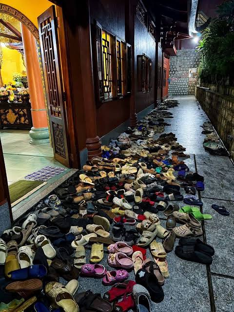 Dozens of pairs of shoes left outside a doorway in Vietnam
