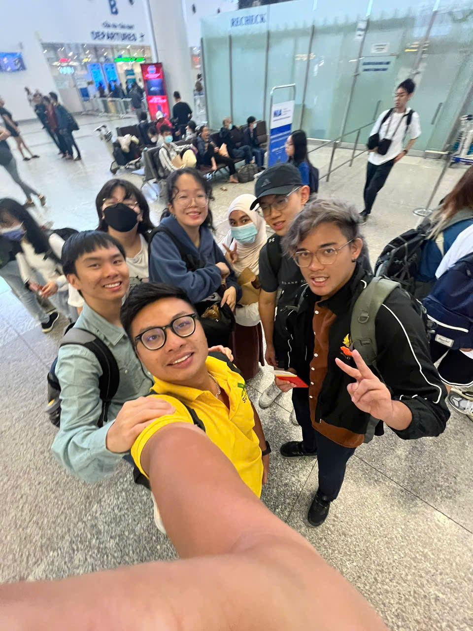 Travellers taking a group selfie on arrival in Vietnam