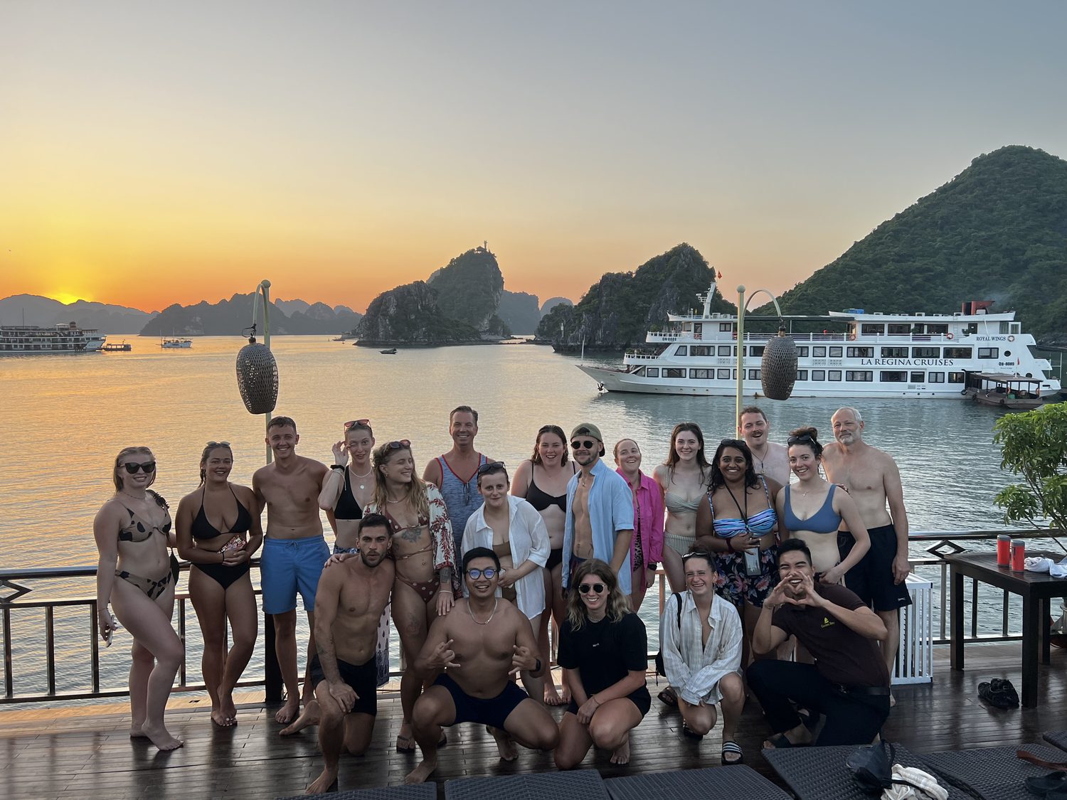 Travellers on the cruise deck at sunset